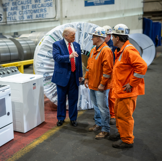 President Trump talking with workers in hard hats